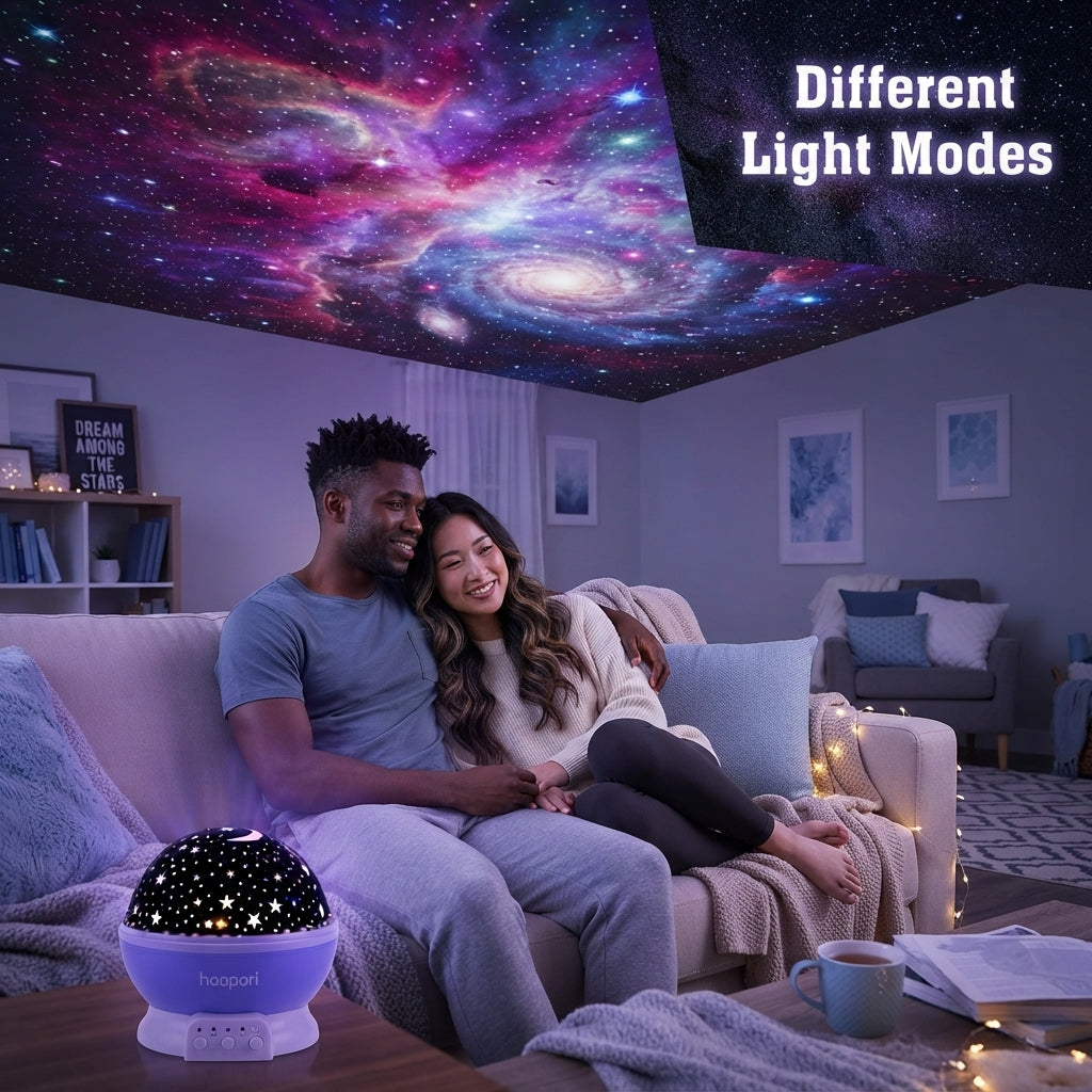 A diverse couple sitting on a sofa watching a starry nebula projected onto the ceiling by a Star Master projector in a cozy r